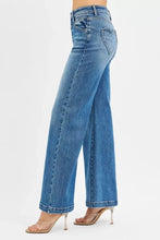 Back view of risen high rise wide leg blue denim jeans with front yoke and heart-shaped back pocket patch