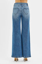 Blue denim jeans with heart-shaped back pockets.
