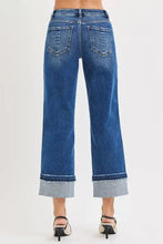Blue denim risen mid rise ankle straight jeans with wide-leg cut and rolled cuffs showing lighter inner fabric