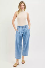 Light-wash denim risen slouchy crop jeans featuring high waist and pleated front in a slouchy crop barrel style