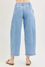 Back view of risen slouchy crop light-wash denim wide-leg cropped jeans with high waist and pleated barrel design