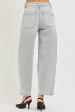 Back side of light-wash risen slouchy cropped barrel jeans with high-rise wide-leg cut and classic back pockets