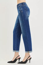 Mid-wash blue denim risen slouchy cropped boyfriend jeans with straight leg cut and rolled cuffed hem