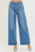 Blue denim risen slouchy wide leg jeans featuring a pleated waistband and rolled cuffs for casual wear