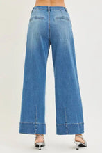 Blue denim risen slouchy wide leg jeans with pleats featuring a classic five-pocket design and rolled cuffs