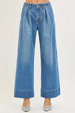 Blue denim risen slouchy wide leg jeans with pleated waistband and rolled cuffs in a wide leg style