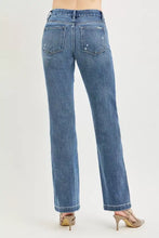 Back view of blue denim risen tummy control jeans with crease line and subtle distressing for a polished aesthetic