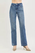 High-waisted blue denim jeans with crease line and subtle distressing for a polished aesthetic at natural waistline