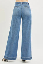 Light-wash blue denim risen tummy control high rise wide jeans showing back side with wide leg and back pockets