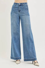 Medium-wash blue denim high rise wide jeans with tummy control elastic band and classic five-pocket design