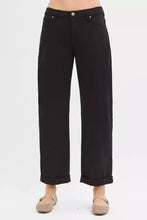 Black wide-leg trousers with risen tummy control, ankle barrel design, sleek straight cut, and rolled cuffs for relaxed fit
