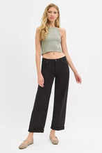 Black high-waisted wide-leg trousers with risen tummy control, ankle barrel cuffs, and a sleek modern cut