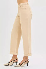 Beige high-rise straight-leg trousers with rolled cuffs and classic five-pocket design featuring risen tummy control