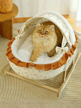 Fluffy orange cat in Rocking Pet Bed with Canopy, rocking motion wooden frame