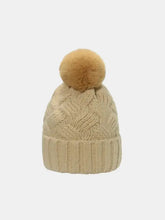Beige roll rim cable-knit beanie hat with brown pom-pom