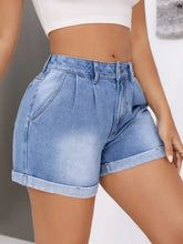 Light wash high-waisted denim shorts with rolled hem and pleats