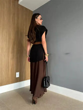 Black quilted chain strap handbag with round neck cap sleeve sweater dress