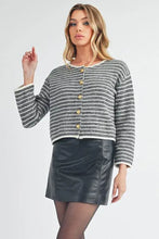 Round neck cardigan in black and white stripes with gold buttons and leather skirt
