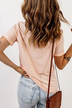 Round neck cuffed short sleeve tee in light peach with jeans and bag