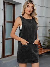 Black denim sleeveless overall dress with front pockets and a round neck denim neckline for casual wear