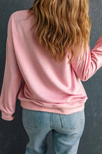 Woman in pink dropped shoulder Amen graphic sweatshirt and blue jeans