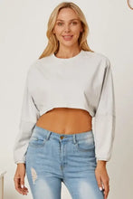 Light grey round neck dropped shoulder cropped sweatshirt with distressed jeans