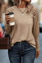 Round neck long sleeve T-shirt with puff sleeves, jeans, and bag