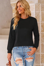 Round neck long sleeve top with distressed blue jeans