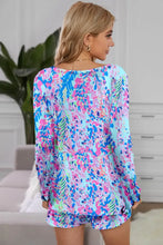 Round neck printed top and shorts lounge set with long sleeve length and abstract floral pattern in pink blue and green