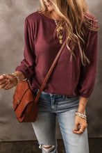 Woman in round neck puff sleeve t-shirt, jeans and crossbody bag