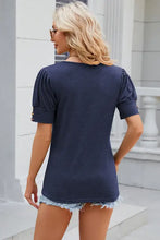 Womens navy blue round neck puff sleeve T-shirt with gold cuff buttons