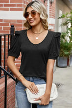 Woman in round neck ruffle trim short sleeve T-shirt, jeans, and clutch