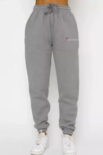 Gray sweatpants with drawstring waistband, cuffed ankles, love forever logo from Round Neck Sweatshirt and Joggers Set
