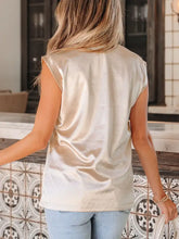 A shimmering cream satin sleeveless round neck tank top with a soft flowing drape for elegant wear