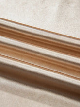 Luxurious warm gold and cream satin-like round neck tank top with smooth texture and subtle sheen