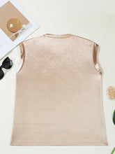 A soft blush pink round neck tank top with subtle textured fabric and shiny satin trim along the armholes