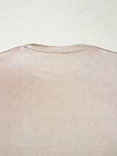 A soft muted pink round neck tank top with smooth textured fabric and neatly stitched neckline perfect for casual wear
