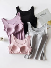 A collection of four seamless underwire-free round neck tanks in pastel lavender light pink black and heather gray
