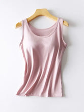 A soft pink round neck tank with sleeveless design and smooth, slightly shiny fabric featuring built-in bra