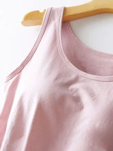A soft pink round neck tank with a sleeveless design and neatly stitched trim featuring an integrated bra