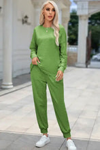 A vibrant green round neck top and drawstring pants lounge set with long sleeve length and relaxed fit joggers
