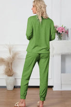 A woman wears a vibrant green round neck top and drawstring pants lounge set with long sleeve length in soft knit fabric