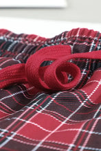 Red and black plaid drawstring pants with white grid pattern part of round neck top lounge set with long sleeve length