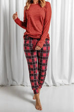 Red and black plaid jogger pants with drawstring waist paired with round neck top featuring long sleeve length for loungewear