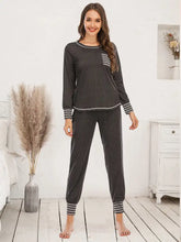 Dark gray long-sleeved round neck top and pants lounge set with white striped cuffs waistband and pocket accents