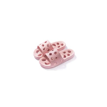 Pair of pink perforated round toe flats slippers