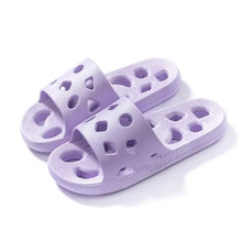 Pair of light purple perforated round toe flats slippers