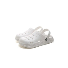 Pair of white round toe platform slippers with ventilation holes and textured sole