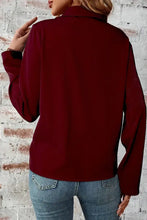 Burgundy fleece turtleneck sweater with ribbed cuffs and long sleeves