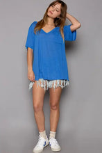 Woman in royal blue loose fit short sleeve V-neck T-shirt with denim shorts